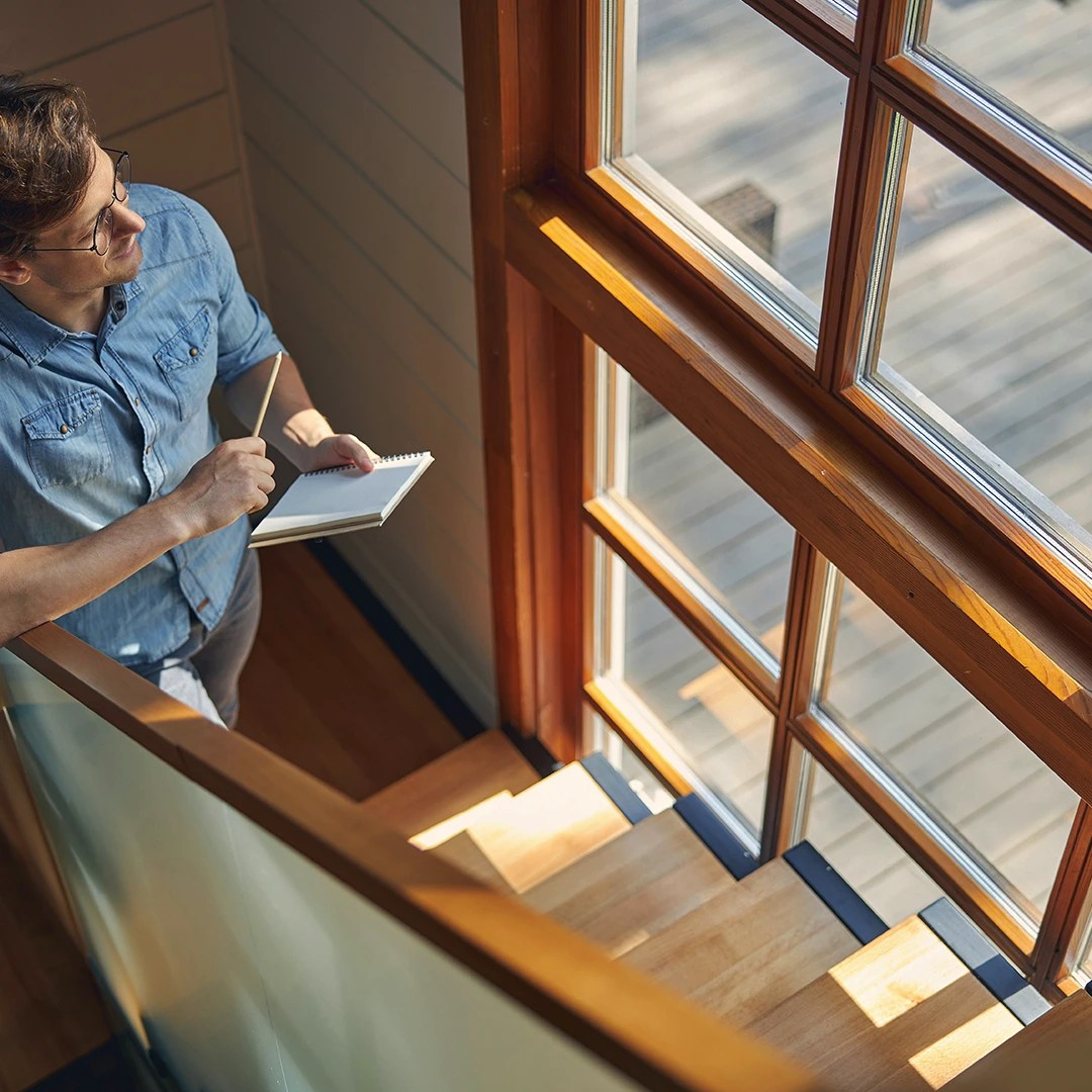 A Man In A Blue Shirt Looking At Fade Reduction Windows.