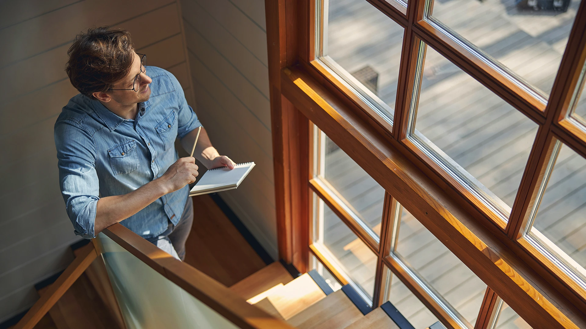 A Man In A Blue Shirt Looking At Fade Reduction Windows.